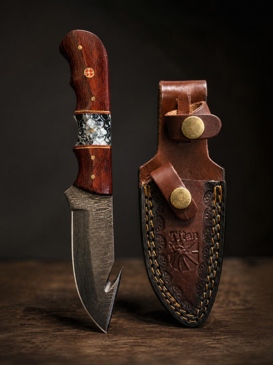 Hand-forged Damascus knife with a rosewood handle standing beside its tooled leather sheath